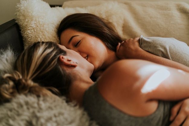 Lesbian couple together in bed