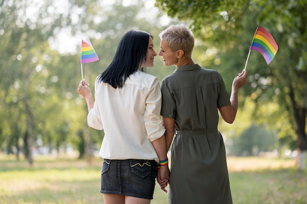 Lesbian couple walking and holding flag