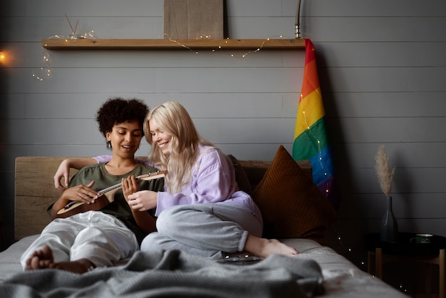 Free photo lesbian couple with rainbow flag