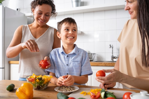 Lesbian couple with their son preparing some food