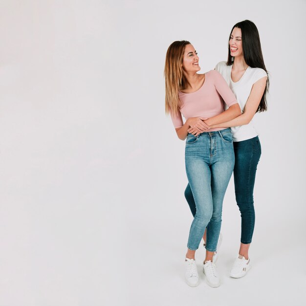 Lesbian women embracing in studio