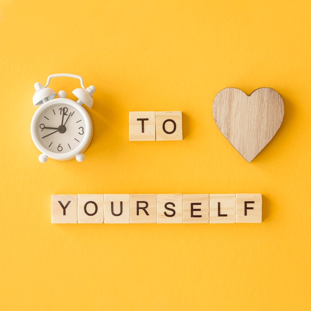 Free photo letter cubes arrangement with old clock