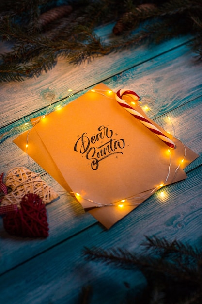 Letter to Dear Santa on a blue wooden table in the Christmas spirit.