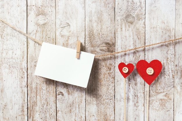 Letter hanging on a rope and two red hearts