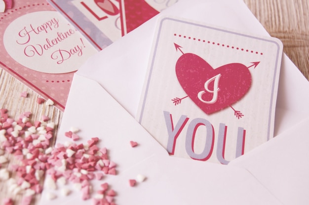 Letter with a postcard with a heart and heart-shaped candies