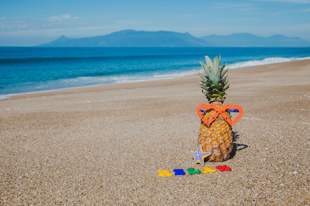 Letters and pineapple in beach