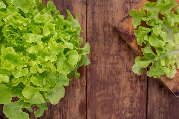 Free photo lettuce  that is placed on a brown wooden floor.