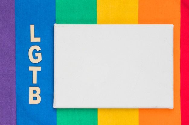 Free photo lgbt abbreviation and white paper sheet on colorful background