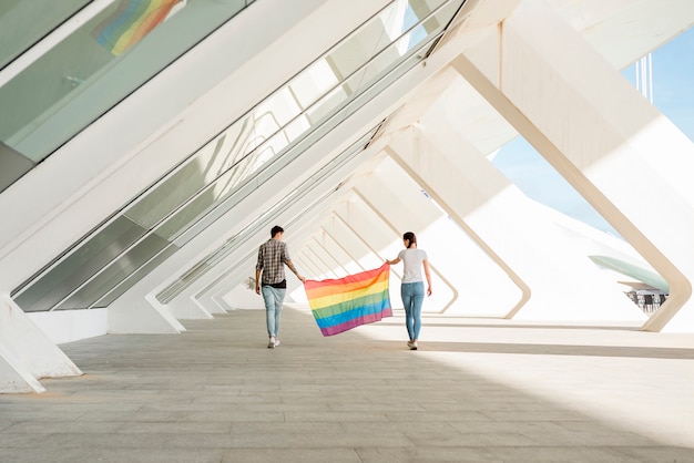 LGBT couple holding rainbow flag