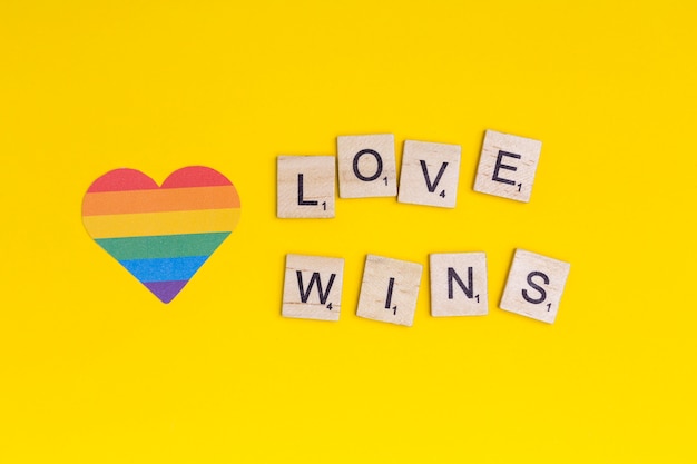 Free Photo lgbt heart icon and word love wins on wooden blocks