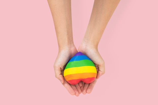 LGBTQ+ community heart with hands presenting