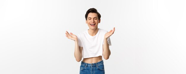 Lgbtq and pride concept happy young gay man smiling laughing and clapping hands from happiness rejoi