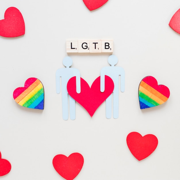 Free photo lgtb inscription with rainbow hearts and gay couple icon