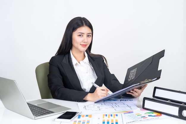 lifestyle beautiful Asian business young woman using laptop computer and smart phone on office desk 