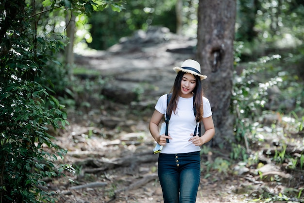 Lifestyle beautiful woman happy torist to travel in wild trip hiking during vacation.