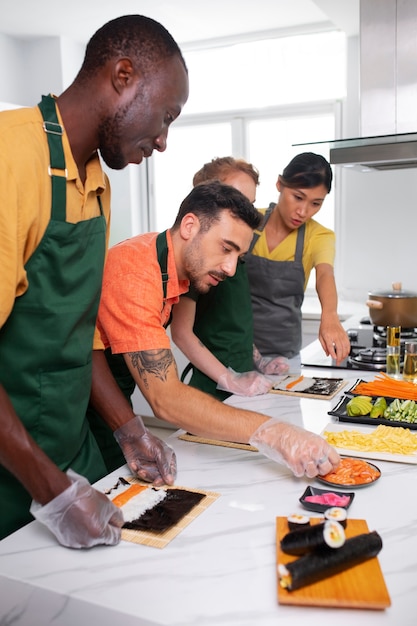 Free photo lifestyle: people learning to make sushi