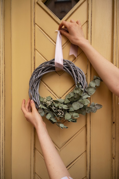 Free photo lifestyle of person decorating their front door