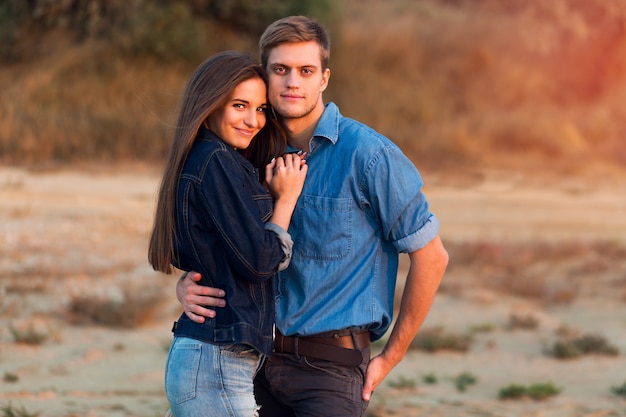 Lifestyle portrait of Young attractive couple in love posing outdoor in the evening .