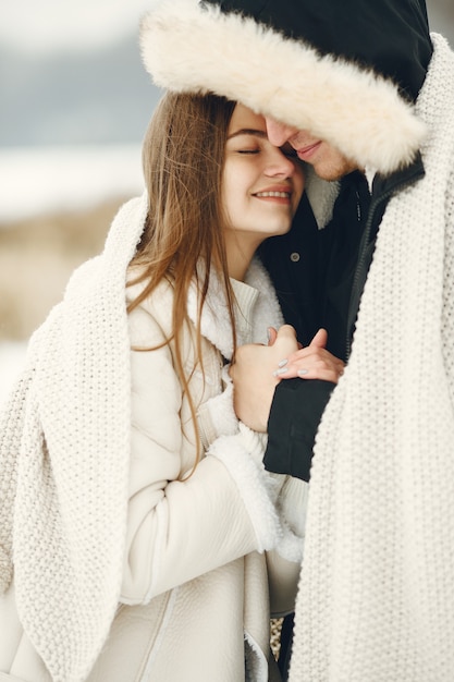 Free Photo lifestyle shot of couple walking in snowy forest. people spending winter vacation outdoors.