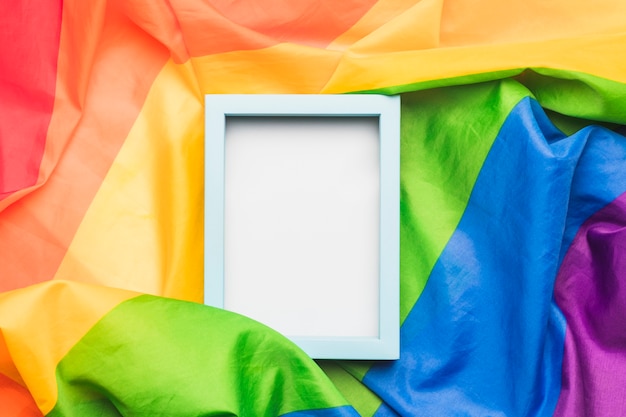 Light blue empty frame on crumpled LGBT flag