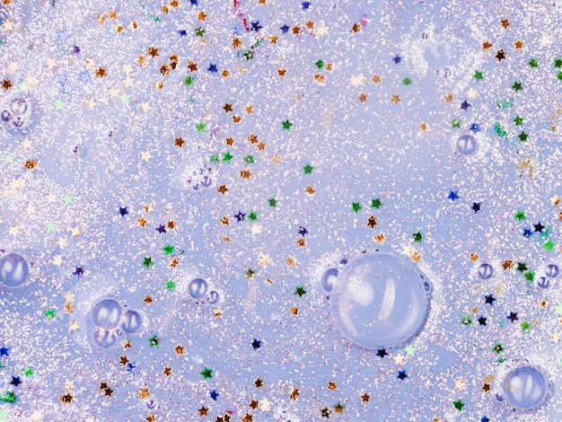 Light blue liquid with blobs and ornamental stars 