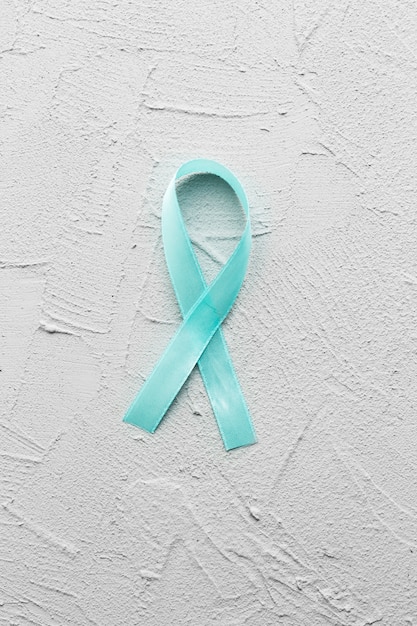 Free Photo light blue ribbon on plaster background