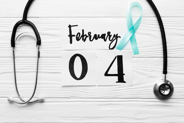 Free Photo light blue ribbon between stethoscope and date