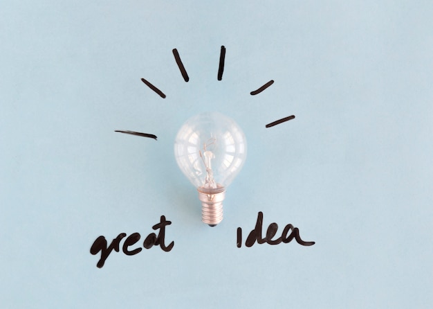 Free photo light bulb with great idea word on blue background