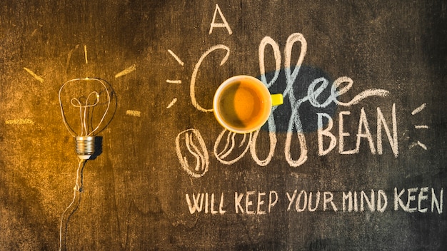 Free photo light over the coffee cup with written text on chalkboard