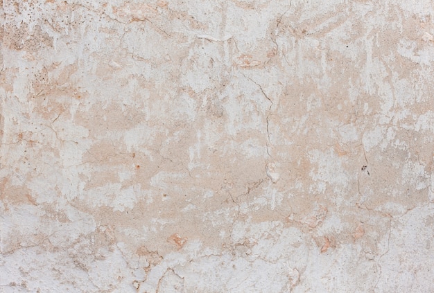 Free Photo light colored cracked stucco wall