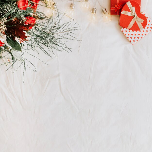 Light garland between presents and bouquet