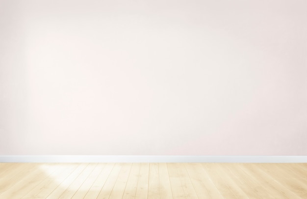 Free photo light pink wall in an empty room with a wooden floor