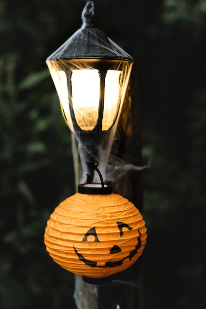 Free Photo light post with spiderweb on halloween