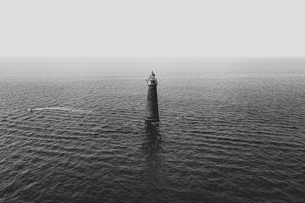 Free Photo a light tower in the middle of the sea