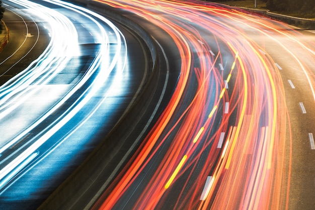 light trails on city street with cityscape