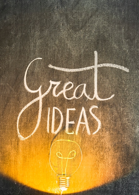 Free Photo lighted bulb on chalkboard with great ideas text