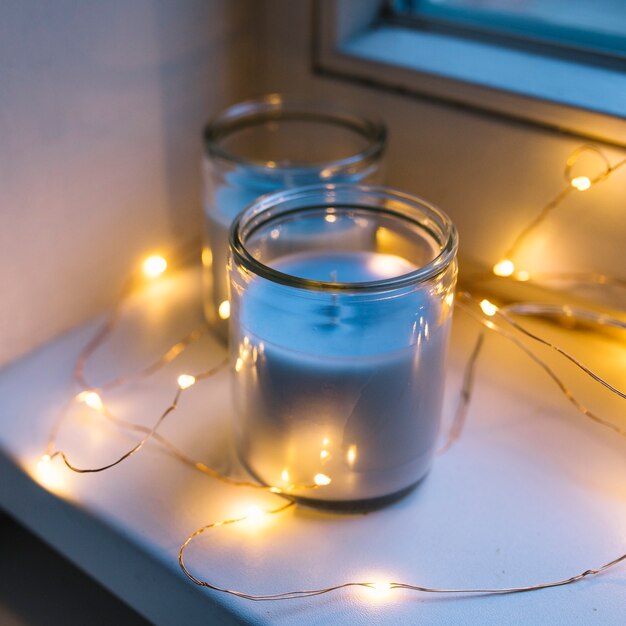 Lighting ferry light around the candle jar on window sill