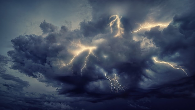 Lightning strike on cloudy sky during night time