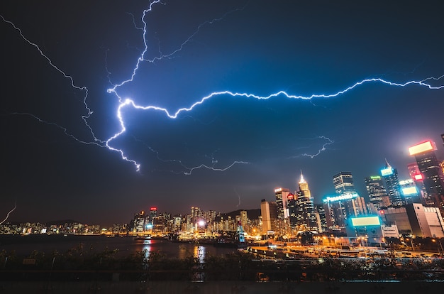 Lightning strike over a modern urban city at night