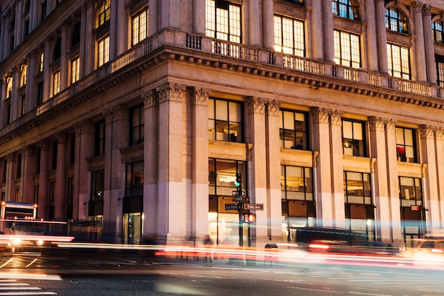 Free Photo lights from cars on background of historic building