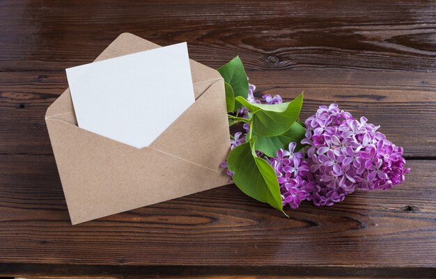 Lilac flowers on wooden table.