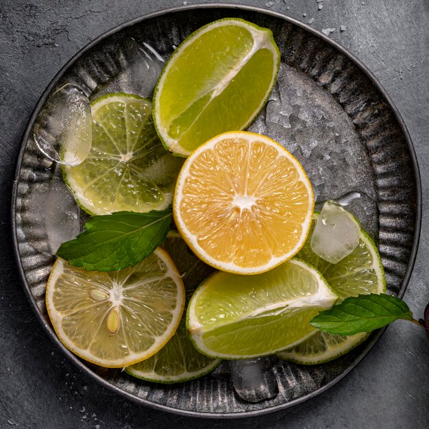 Lime and lemon slices on plate flat lay