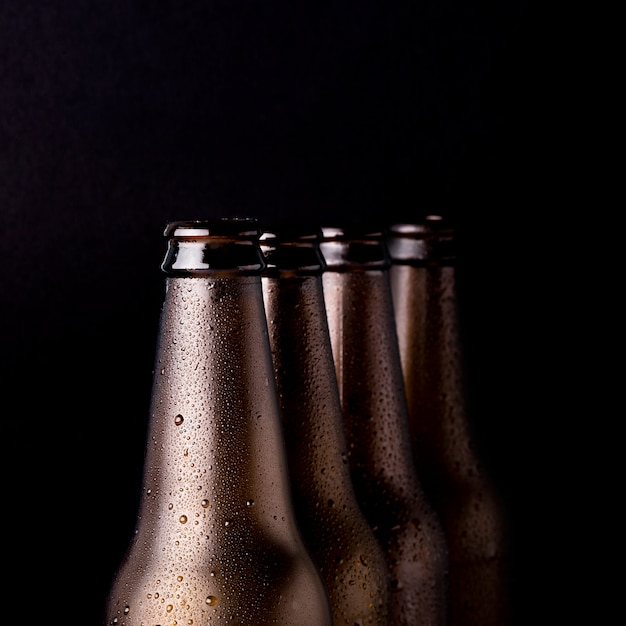 Free photo line of black beer bottles