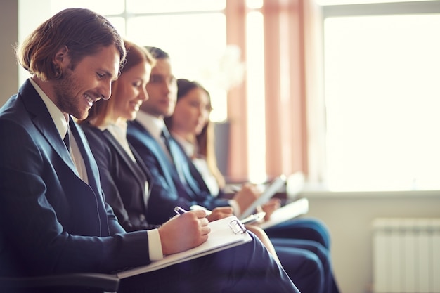 Line of co-workers in a meeting