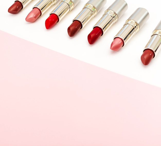 Free photo line of metallic lipsticks on white background