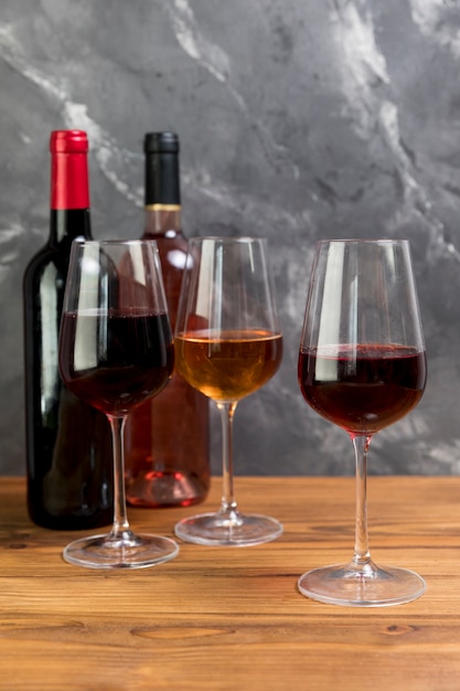 Free photo line of wine bottles and wineglasses