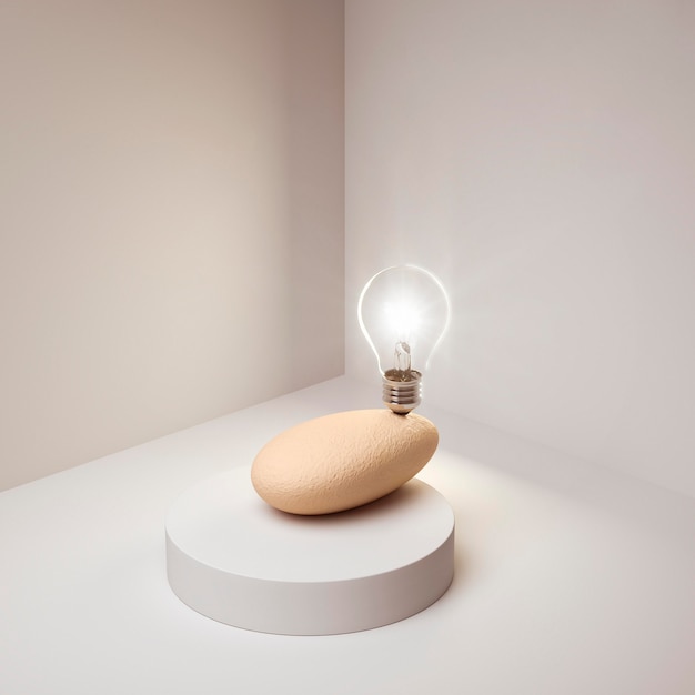 Free Photo lit lightbulb as an idea concept balancing on rock