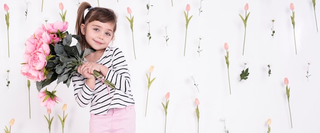 Little adorable girl holding roses