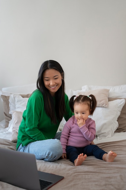 Little asian girl spending time at home with her mother