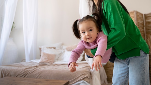 Little asian girl spending time at home with her mother